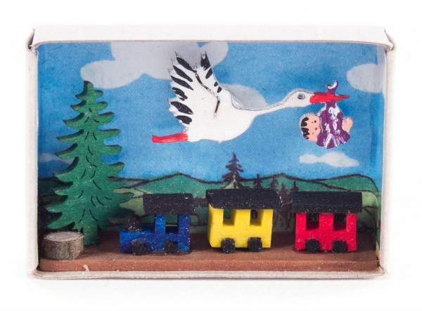 Dregeno Erzgebirge - Zündholzschachtel mit Storch, Baby und Eisenbahn